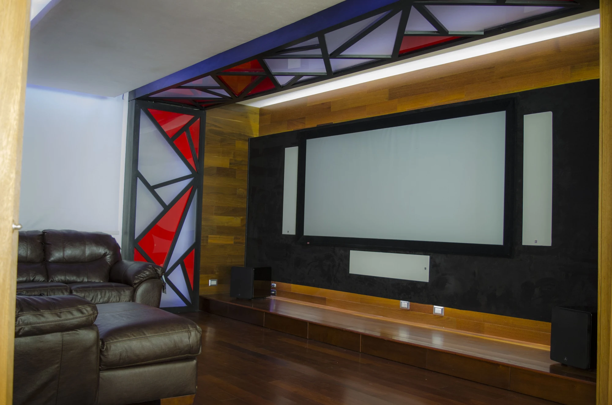 Private cinema installation with acoustic wall treatment and a projection screen