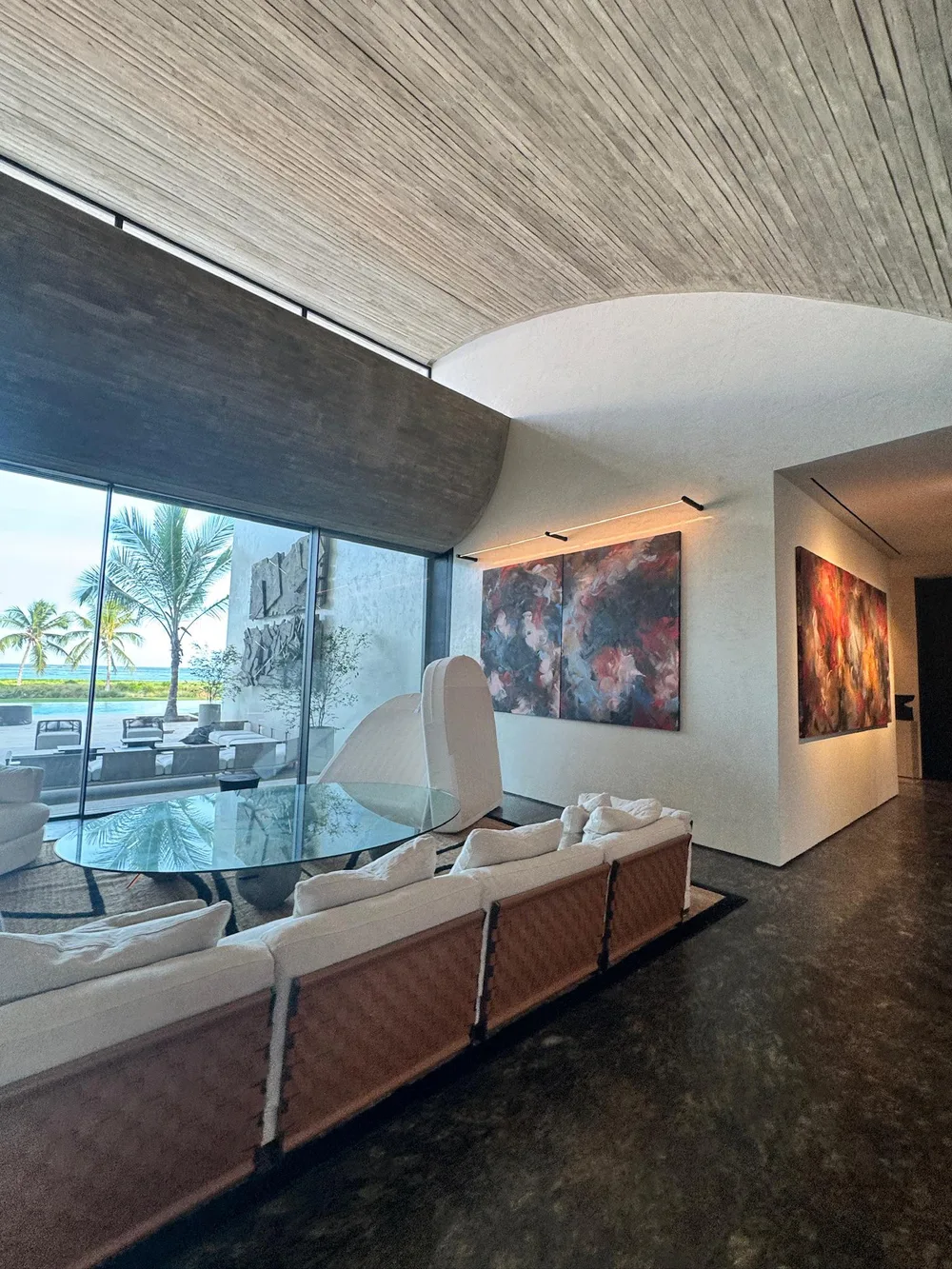 Ocean-view living room at Arrecife under a curved wood ceiling